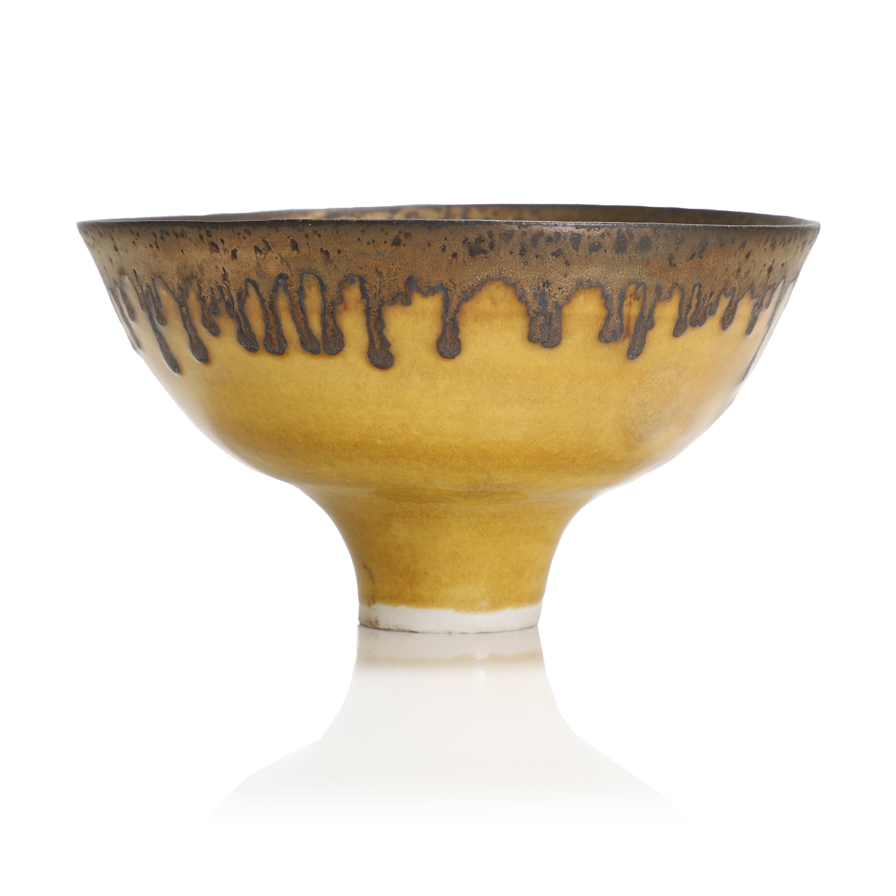  Dame Lucie Rie (Austrian, 1902-1995) a porcelain bowl, with a yellow glaze and manganese rim, impressed to the bottom of the foot with the artist's seal, 19cm diameter 10cm high (£8,000-12,000)